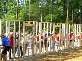 Habitat for Humanity volunteers constructing a wall