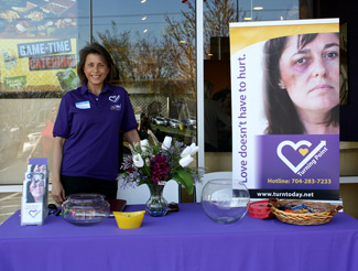 Turning Point volunteer at information table